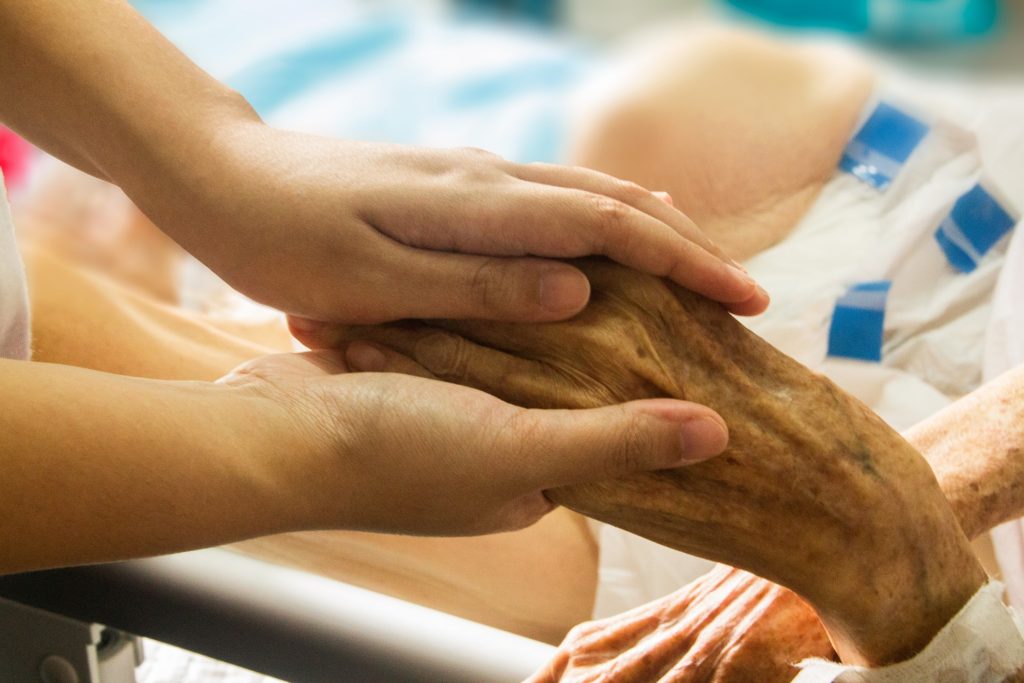 person holding an older persons hand