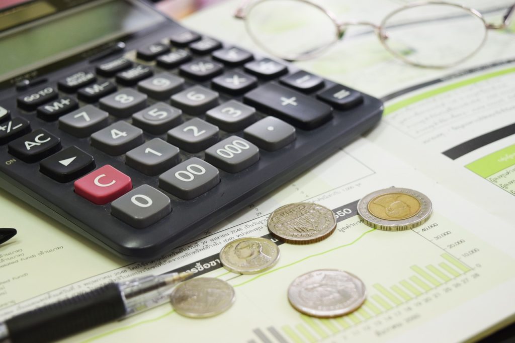 Calculator, coins and financial statements